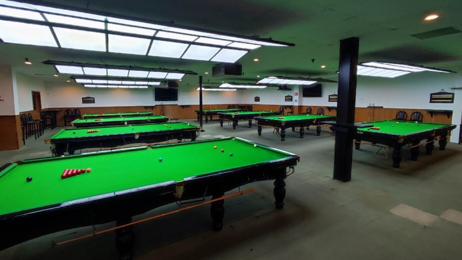 A view inside of the Embassy Billiards Club and the eight snooker tables in the main area